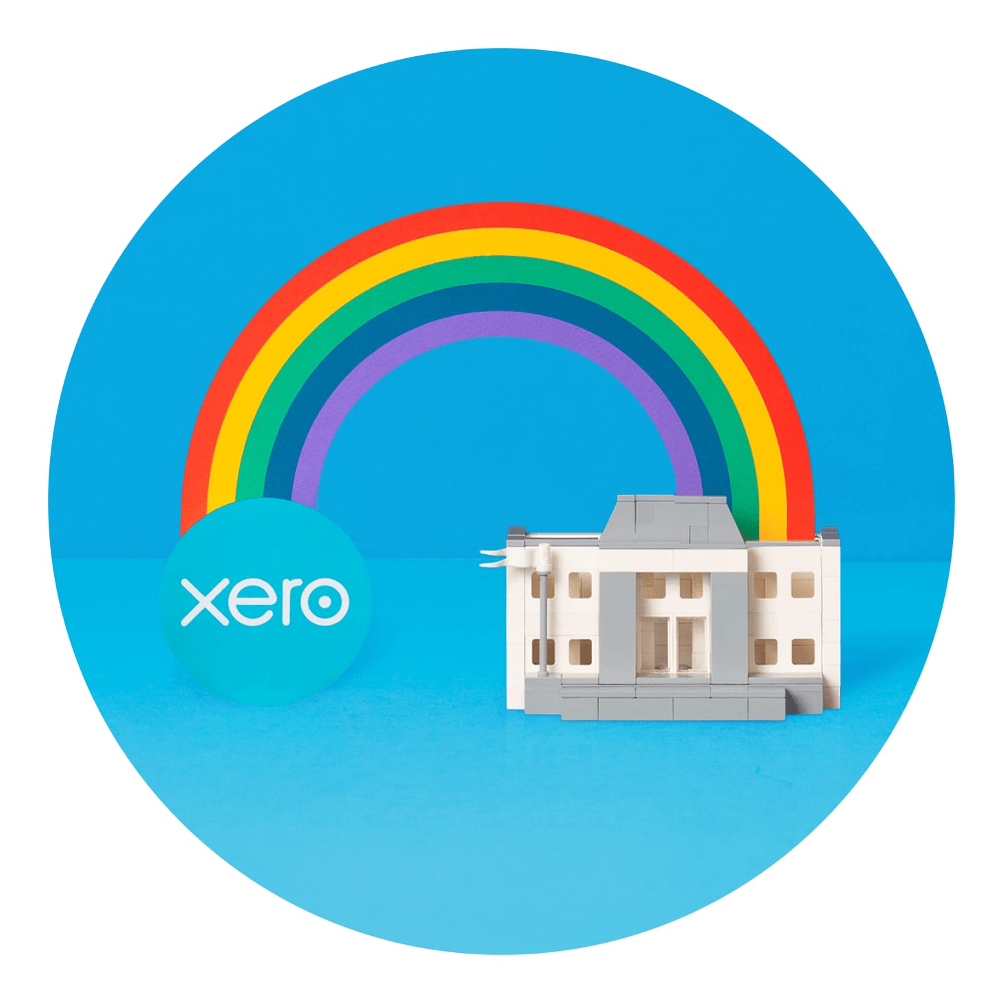 A rainbow arches between Xero and an Inland Revenue office building.