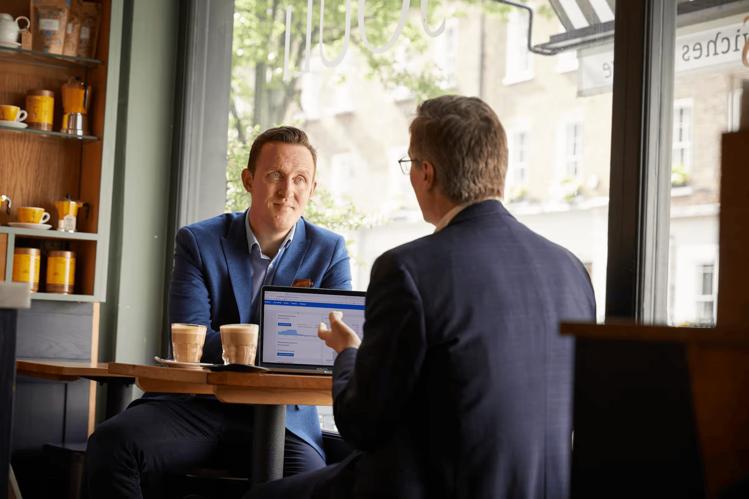 A consultant meeting with a client and using Xero accounting software on their laptop.