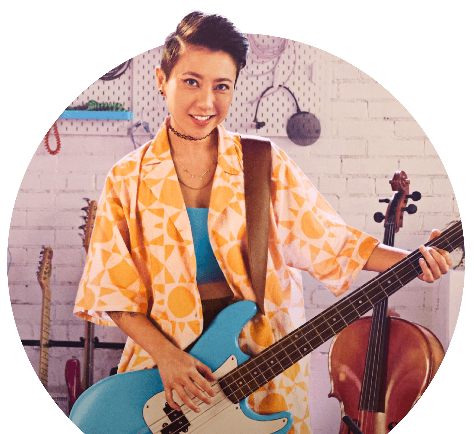 A DJ small business owner poses to camera playing her guitar
