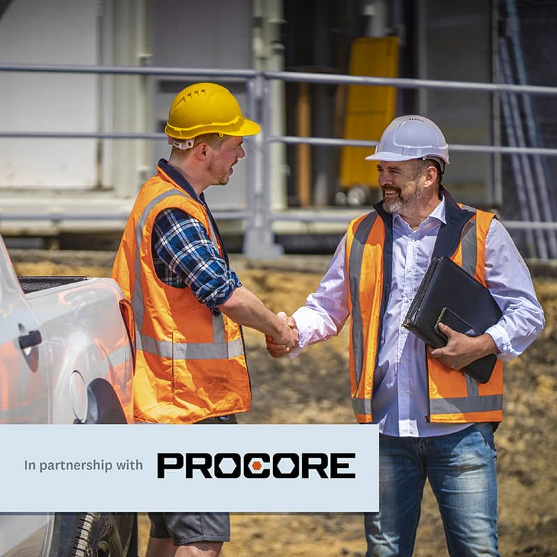 Two men wearing hi-vis jackets on a work site while shaking hands. On the top is text that reads ‘In partnership with Procore