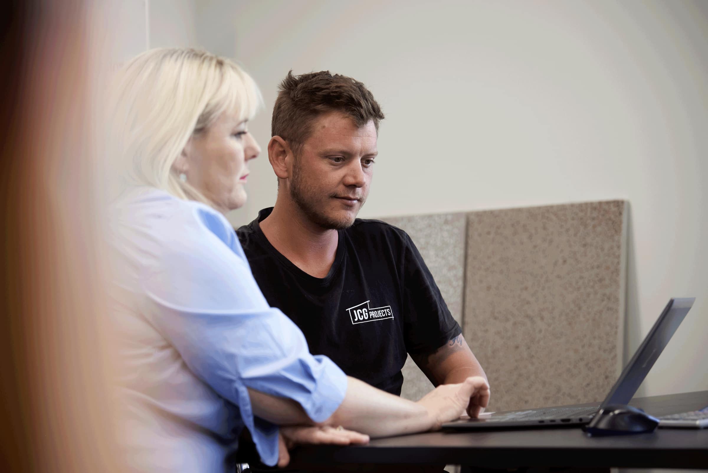 Johnno and bookkeeper, Olivia, work on his accounts