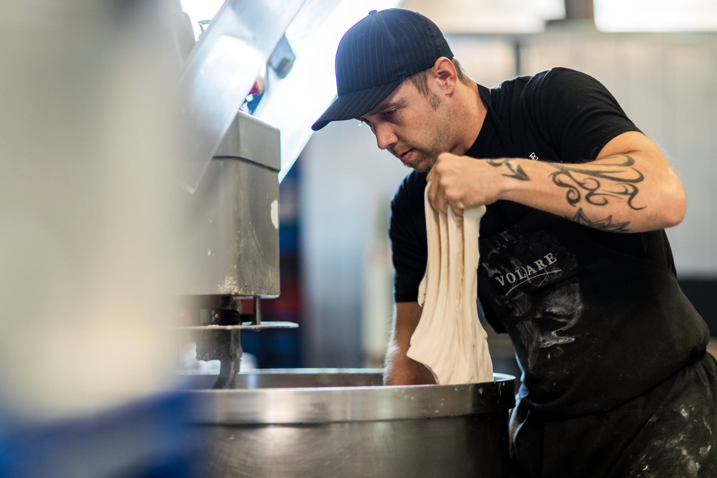 Ed from Volare bakery kneads dough. He uses Xero accounting software to run his business.