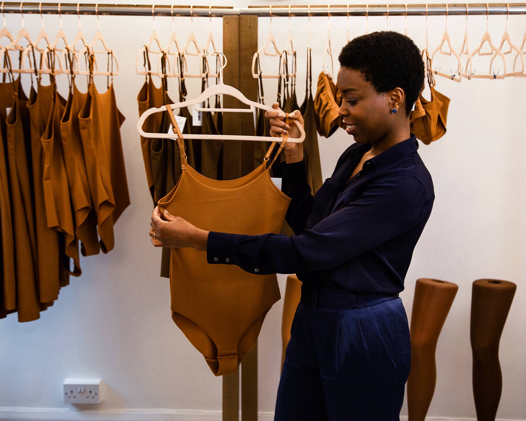 Woman organising clothes in her store