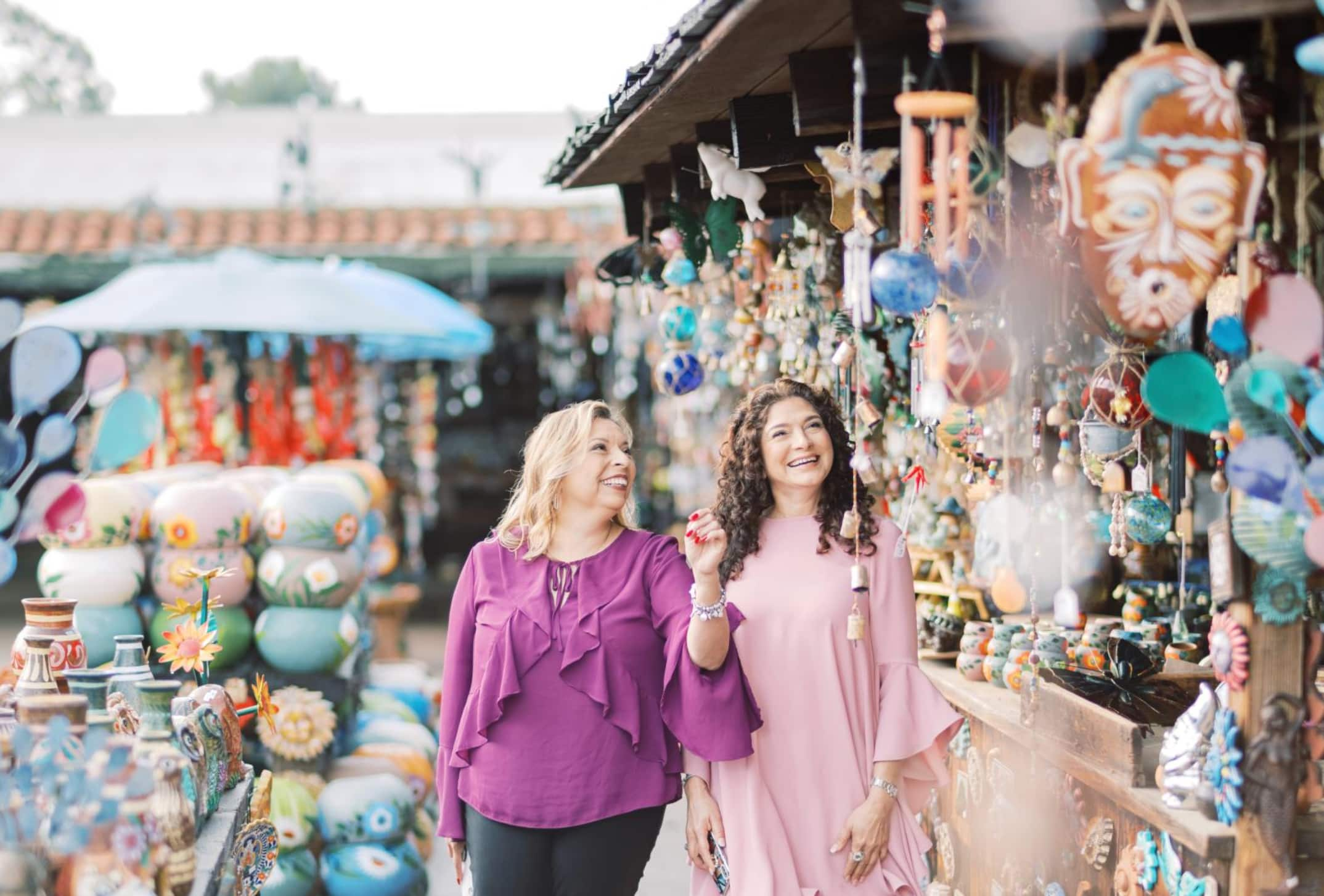 Nury Saenz and a friend at a local market, surrounded by crafts