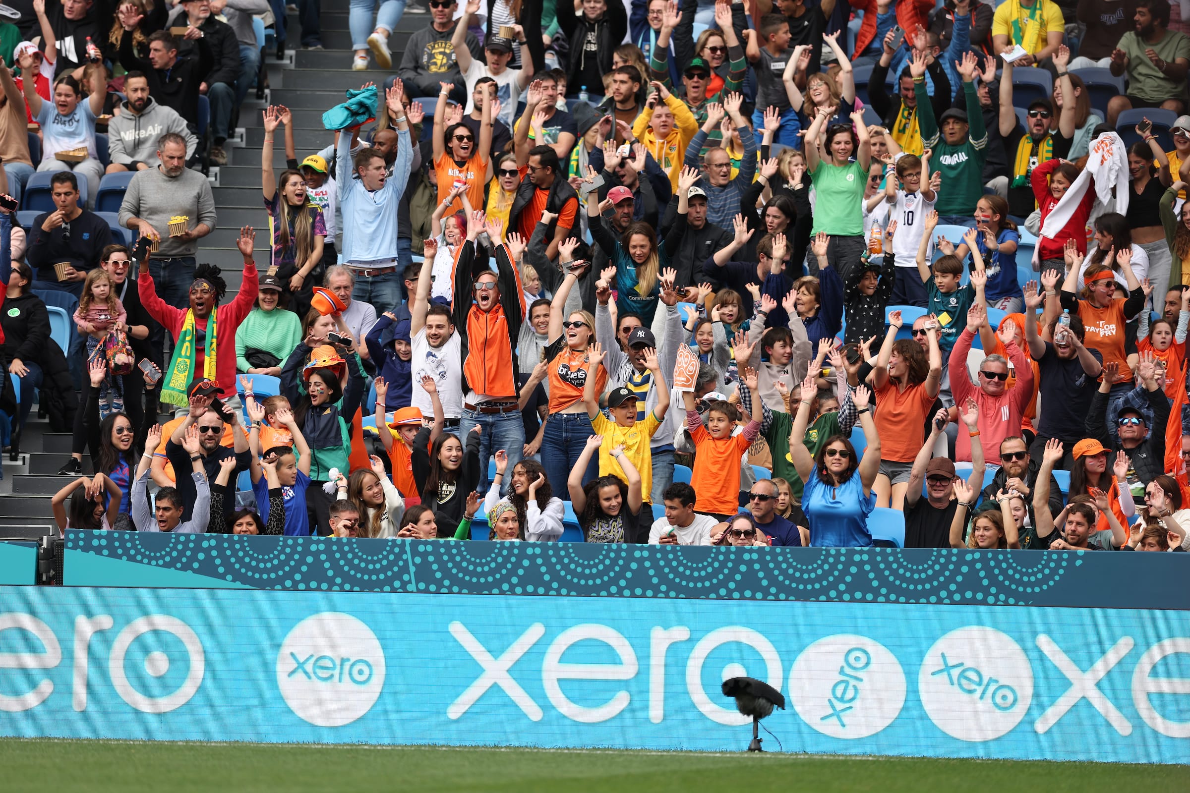 Supporters at a football game and a Xero banner