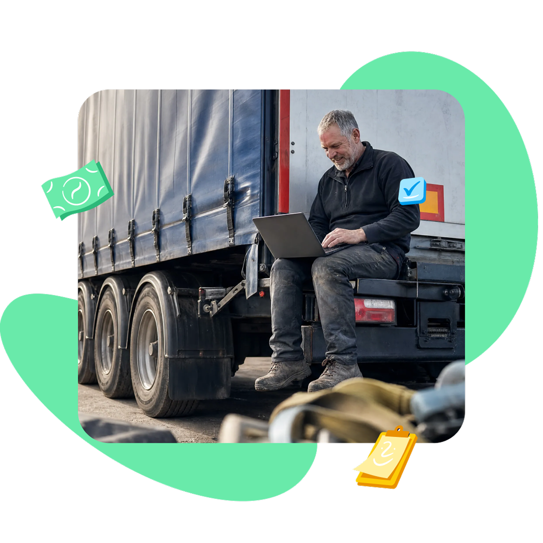 Truck driver sitting on the back of a semi-trailer, working on a laptop