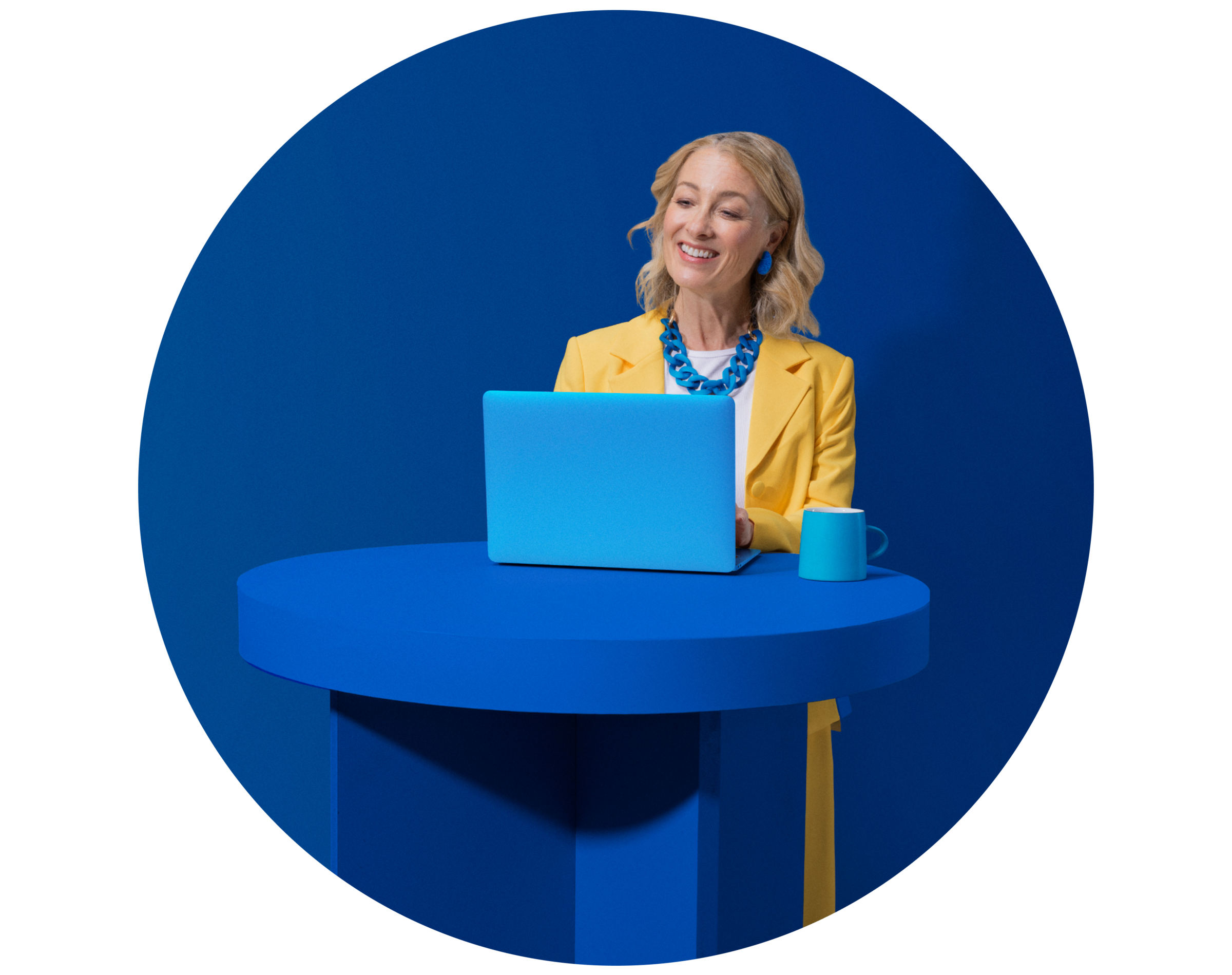Lady standing and smiling at laptop