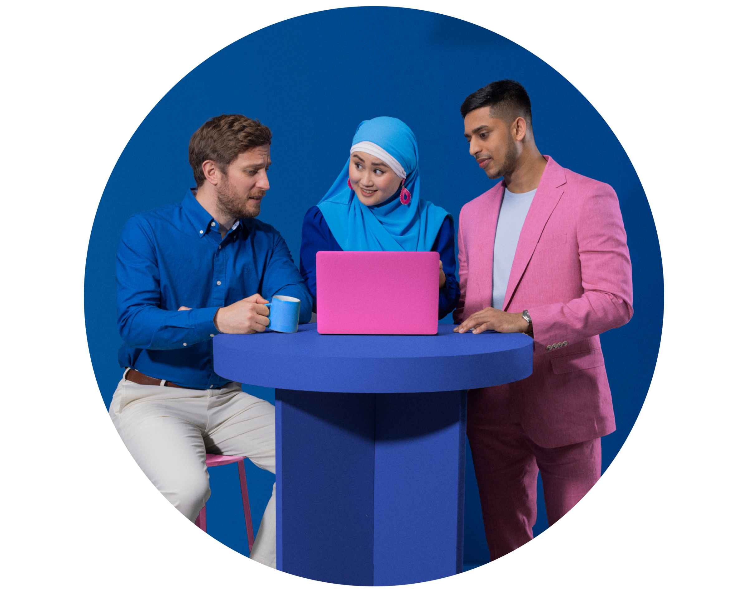 Large group standing round a laptop