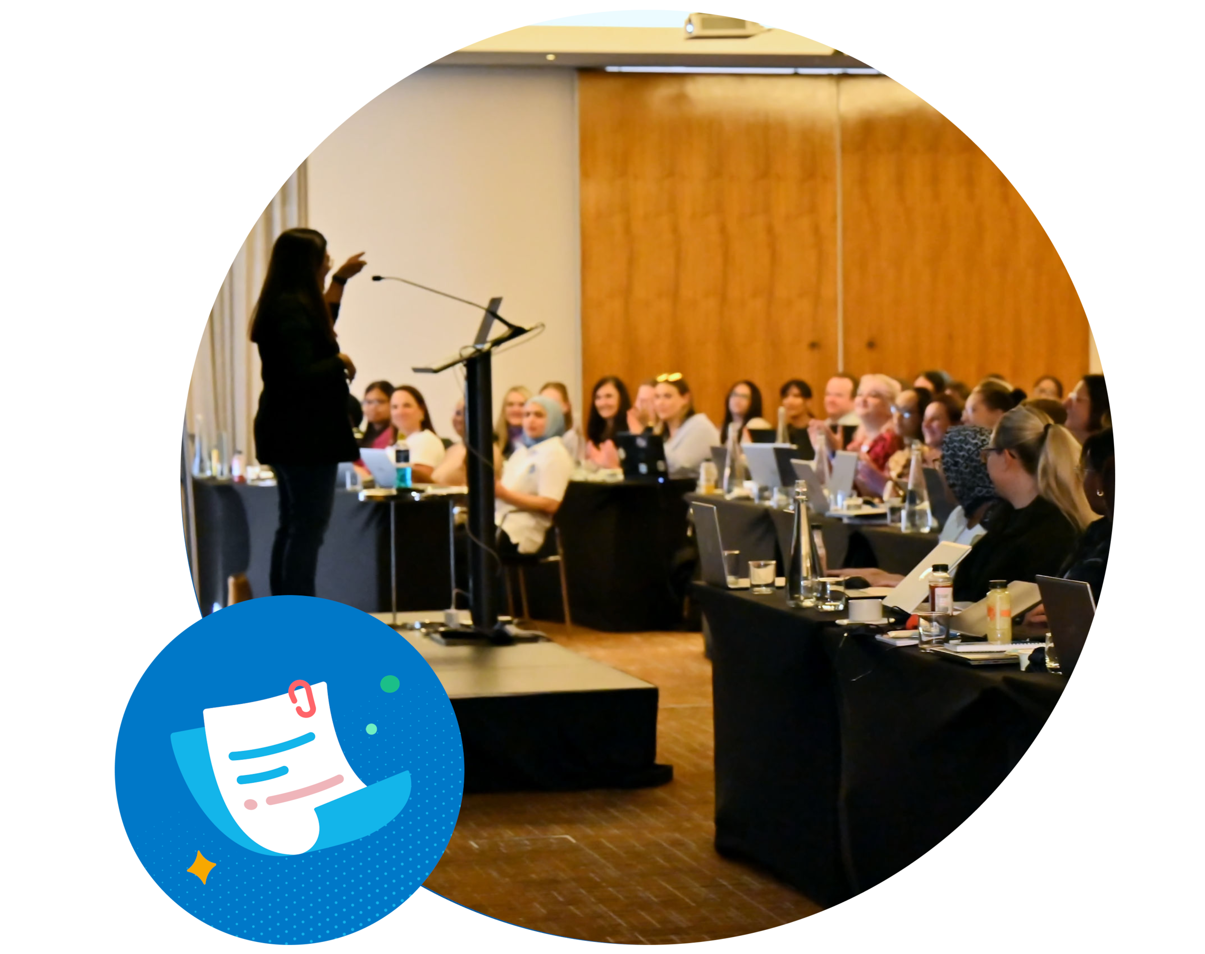 A speaker stands at a podium, in front of a class of students teaching them how to use accounting software.