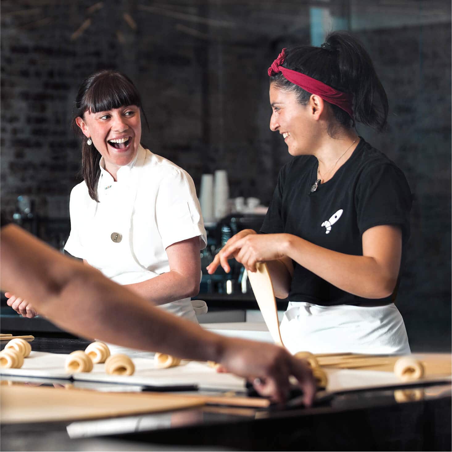Two bakers prepare pastries, free of the need to manually enter bills.