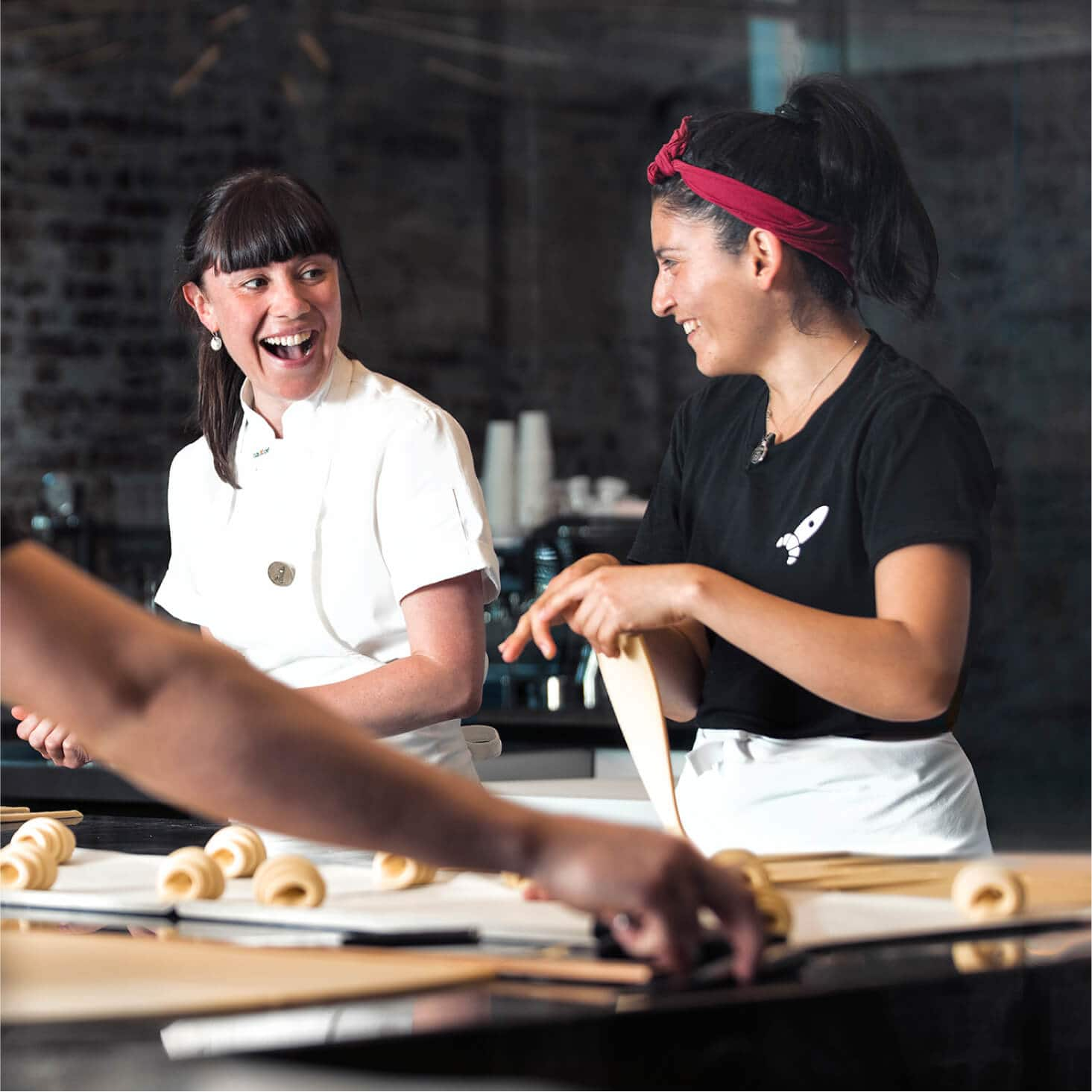 Two bakers prepare pastries, free of the need to manually enter bills