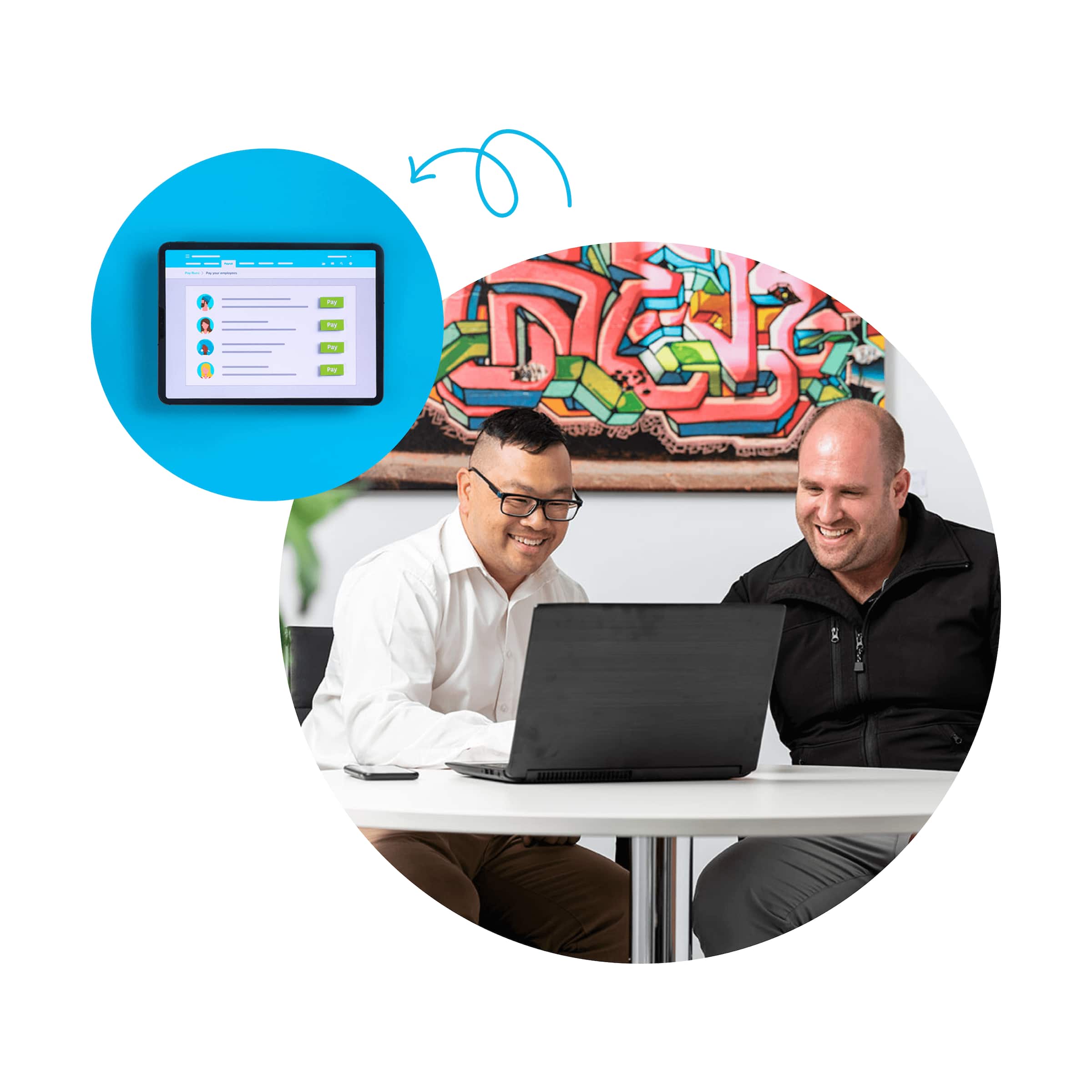 An employee and their manager sit side-by-side in front of an open laptop