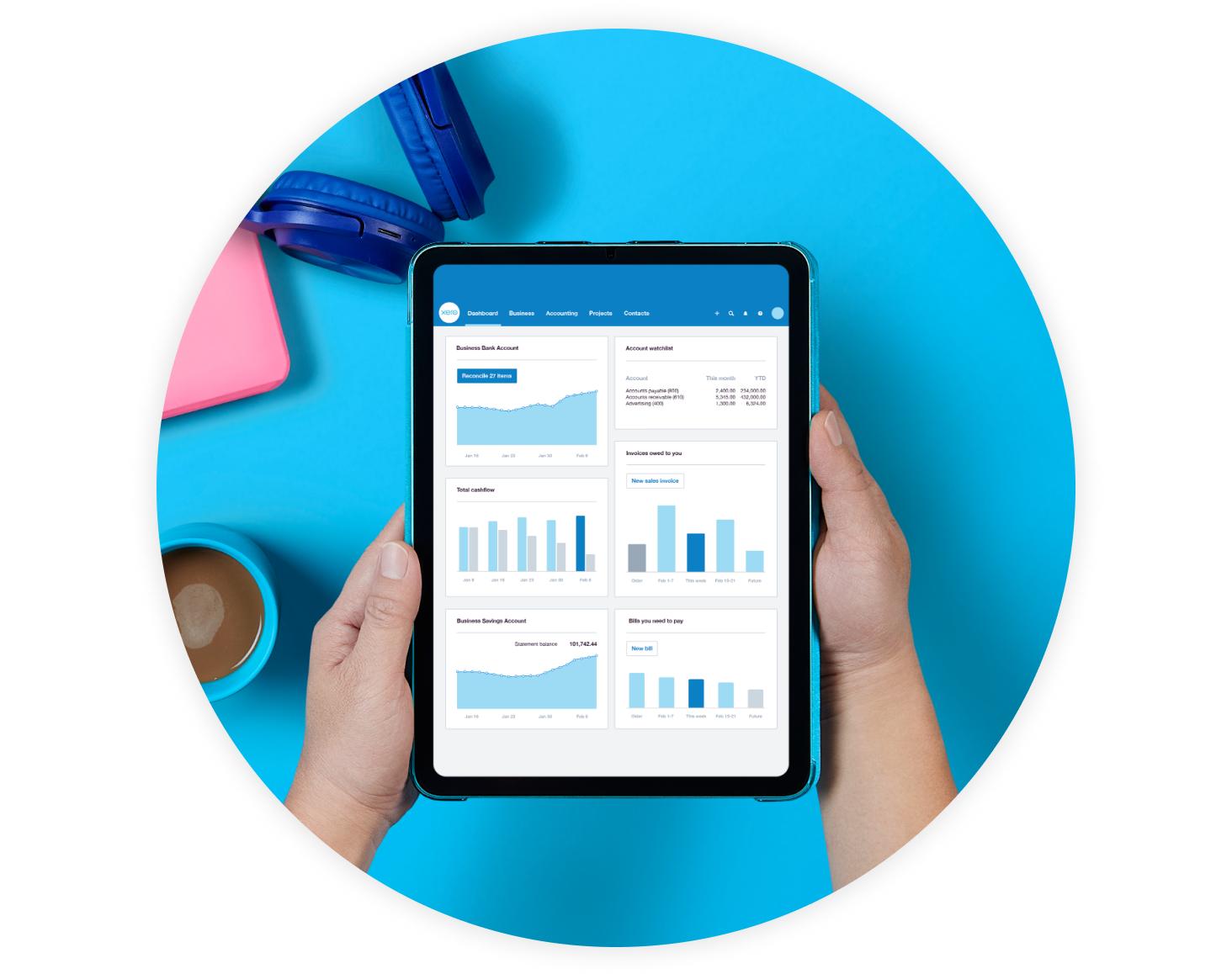 Two hands holding a tablet that displays the Xero dashboard.